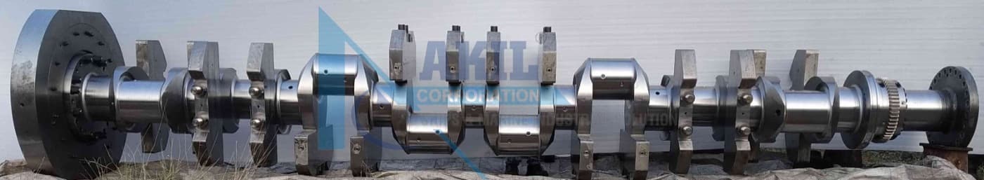 MAN B&W 16V32/40 crankshaft laid out full length on the yard floor